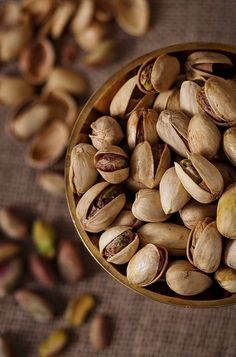 pistachio nuts in a bowl on a table