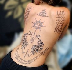 a woman with tattoos on her back