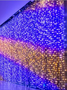 colorful lights are on the side of a building