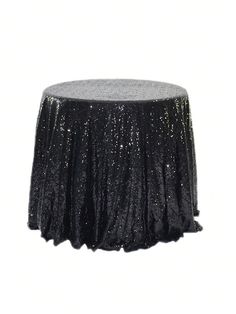 a black table cloth with silver sequins on the top is shown in front of a white background