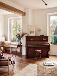 a living room filled with furniture and a piano