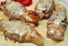 chicken covered in gravy and garnished with tomatoes