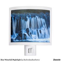 a night light with a waterfall scene on it