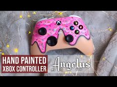 an image of a hand painted controller for the nintendo wii game console, with pink sprinkles on it