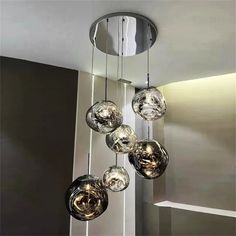 a modern chandelier hanging from the ceiling