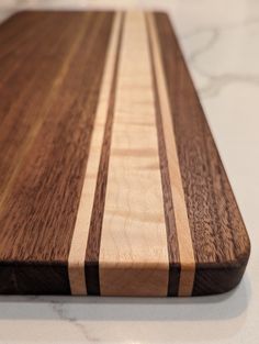 a wooden cutting board sitting on top of a counter