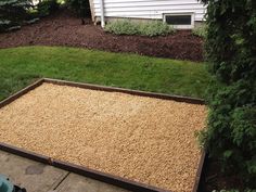 a yard with gravel and grass in the middle