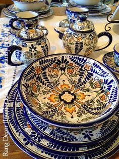 a table topped with lots of blue and white dishes