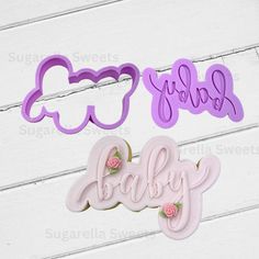 two cookie cutters with the word baby spelled in cursive letters and flowers