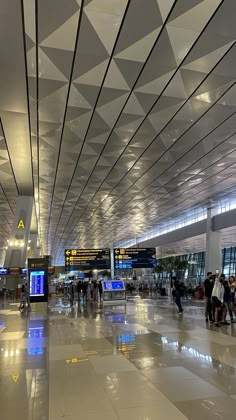 many people are walking through an airport terminal