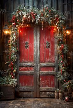 an old red door decorated with christmas garland and lights