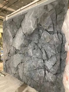 a large rock wall in a warehouse