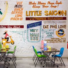 a restaurant with colorful chairs and signs on the wall