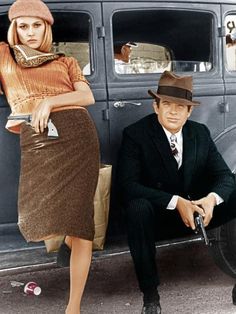 a man sitting next to a woman in front of a car