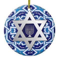 a star of david ornament hanging from a string on a white background with blue and gold designs