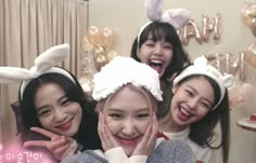 three girls in bunny ears are posing for the camera with their hands on their face