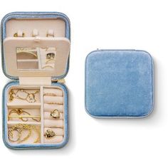 an open blue case filled with lots of jewelry