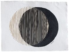 a black and white circle on top of a piece of paper with strips in it