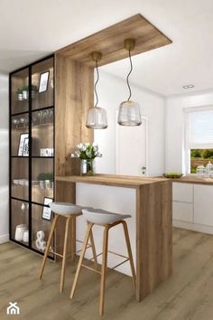 a kitchen with two stools next to a bar