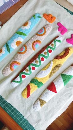 three crocheted toothbrush holders sitting on top of a table next to each other