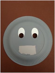 a paper plate with a face drawn on it