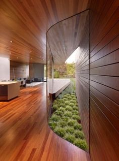 an image of a room with wood floors and grass growing on the floor in front of it