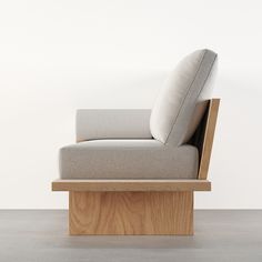 a chair that is sitting on top of a wooden stand in front of a white wall