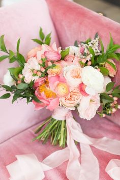 a bridal bouquet on a pink velvet chair