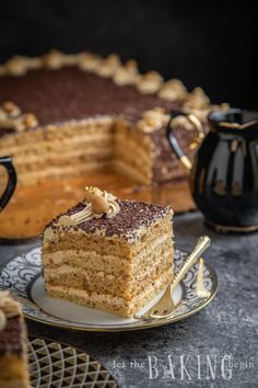 a piece of cake sitting on top of a plate next to a cup and saucer