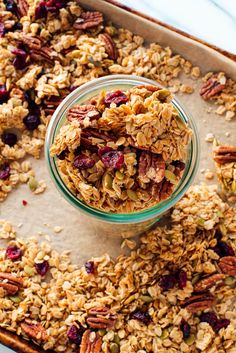 granola in a glass bowl with nuts and cranberries