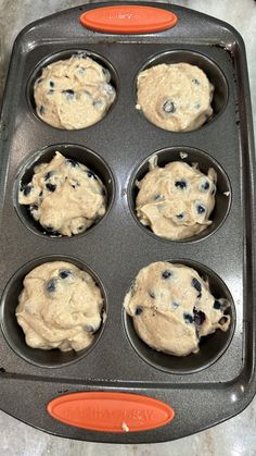 an orange and black tray filled with muffins