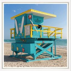 a life guard stand on the beach with surfboards