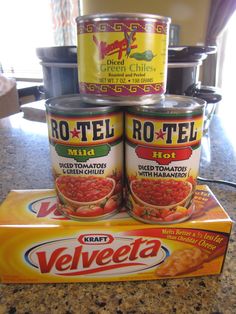 three cans of canned food sitting on top of a counter