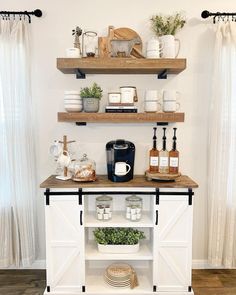 a kitchen with open shelving and shelves filled with dishes, coffee mugs and other items