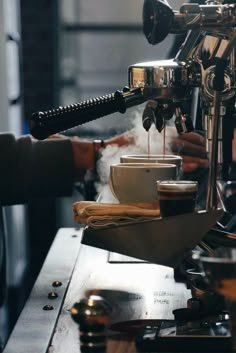 two people are working on a coffee machine