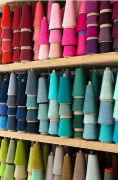 several rows of spools of thread on shelves