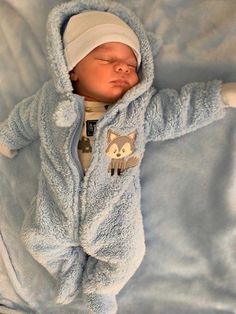 a newborn baby wrapped in a blue blanket