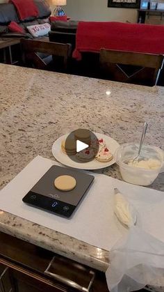 a kitchen counter top with a plate and bowl on it next to a remote control