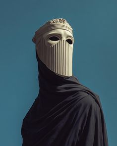 a person wearing a mask and black cloak