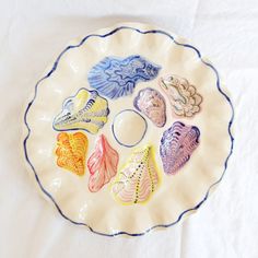 a white plate topped with different types of sea shells