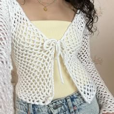 a close up of a person wearing shorts and a top with crochet on it