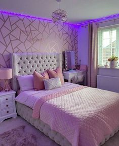 a bedroom with purple and white decor in the corner, along with a large bed that has pink pillows on it