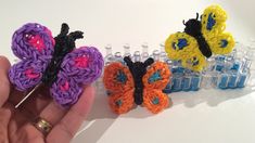 someone is holding some crochet butterflies in their hand and they are all different colors