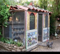 a chicken coop in the middle of a garden