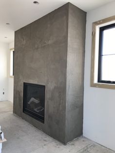 an empty room with a fireplace in the middle