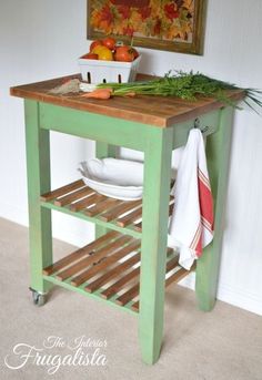 a kitchen island with plates and bowls on it in front of a painting hanging on the wall