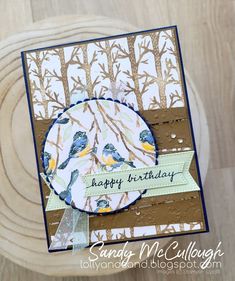 a close up of a birthday card on a wooden table with a wood slice in the background