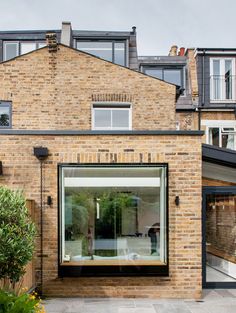 a brick house with an open glass door