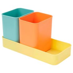 three different colored plastic containers sitting on top of each other