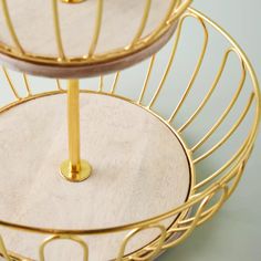 three tiered trays with gold metal handles and circular plates on each one side